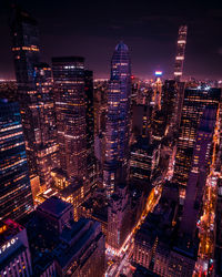 Aerial view of illuminated buildings in city at night