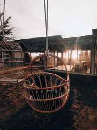 Abandoned shopping cart on field against sky