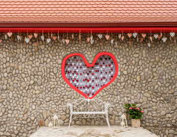 Love scene for taking pictures with an iron bench and a frame with a red heart in the center