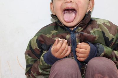 Portrait of boy sitting on sofa