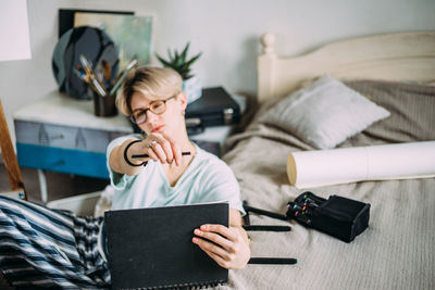 Woman using mobile phone at home