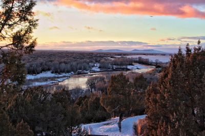 Scenic view of landscape against sky during winter