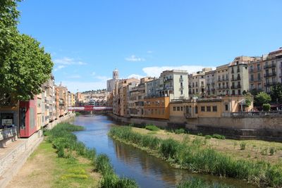 Canal amidst buildings against sky