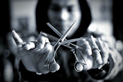Close-up of man holding scissors