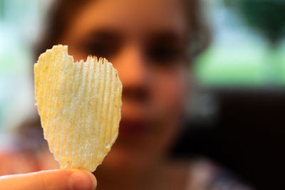 Woman holding heart shape potato chip