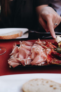 Close-up of person preparing food on table