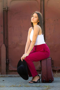 Portrait of young woman sitting outdoors