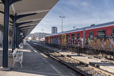 Train at railroad station platform against sky