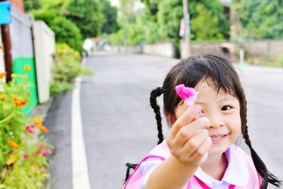 Close-up of girl with pink flowers