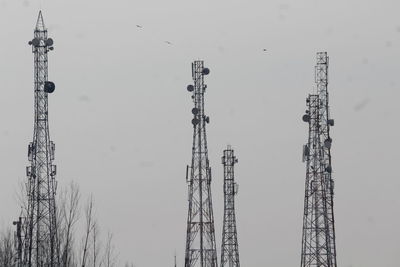 Low angle view of communications tower against sky