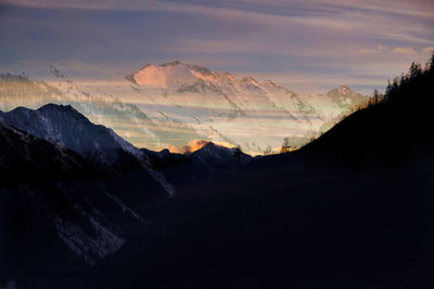 Scenic view of snowcapped mountains against sky during sunset