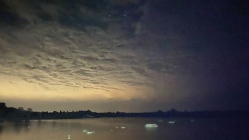 Scenic view of lake against sky at sunset