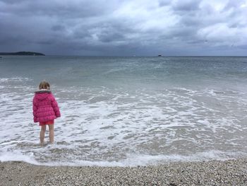 Rear view of person standing on beach