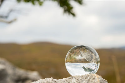 Close-up of crystal ball on rock