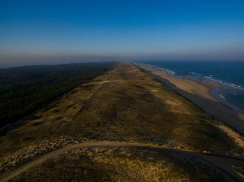 Scenic view of beach against blue sky