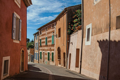 Colorful houses in ocher and street in the city center of roussillon, france.