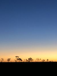 Silhouette landscape against clear sky during sunset