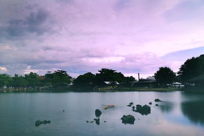 Scenic view of lake against sky at sunset