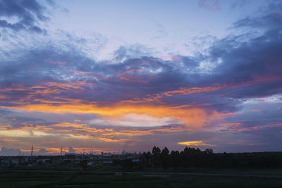 Scenic view of silhouette field against sky at sunset
