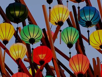 Low angle view of lanterns hanging against sky