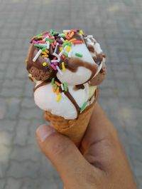 Close-up of hand holding ice cream cone