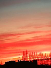 Silhouette buildings against sky during sunset