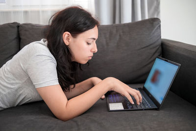 Young woman using laptop at home