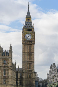 Low angle view of clock tower against sky