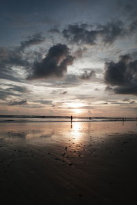 Scenic view of beach against sky during sunset