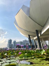 View of modern buildings against cloudy sky