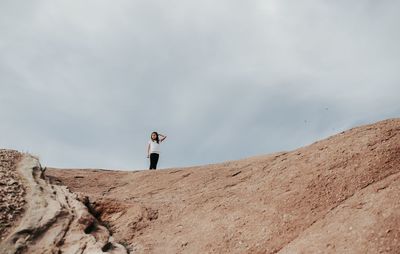 Woman standing against sky