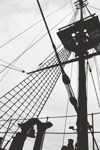 Low angle view of silhouette chain swing ride against sky