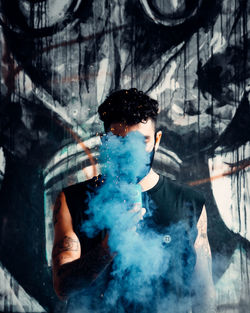 Digital composite image of young man smoking