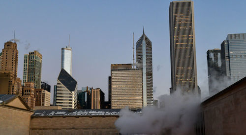 Modern buildings in city against clear sky