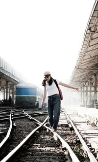 Woman walking on bridge in city