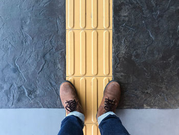 Low section of man standing on floor