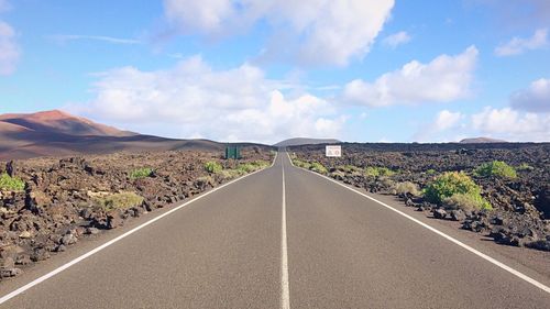 Highway amidst landscape against sky