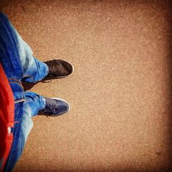 Low section of man standing on tiled floor