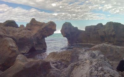 Close-up of rocks on beach against sky