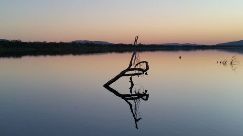 Scenic view of lake against sky at sunset