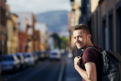 Portrait of man on street in city