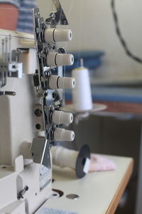 Close-up of sewing machinery at table