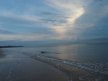 Scenic view of beach against sky during sunset