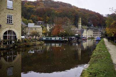 Reflection of trees and buildings in canal