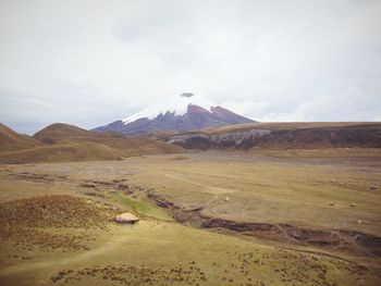 Scenic view of mountains against cloudy sky