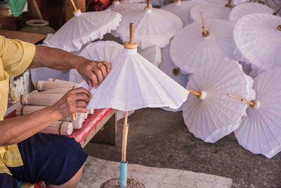 Midsection of man making umbrella