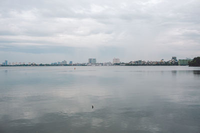 Scenic view of lake in city