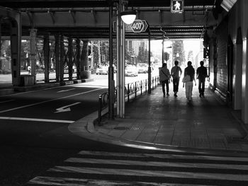 People walking in illuminated city