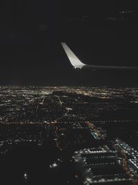 Aerial view of illuminated city against sky at night