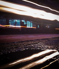 Light trails on road in city at night